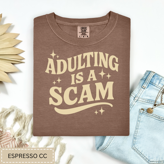 Adulting Is a Scam Tee.